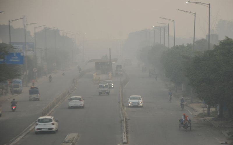 Commuters navigate through a thick blanket of smog on Verka Road in Amritsar on Friday. Photo: Vishal Kumar